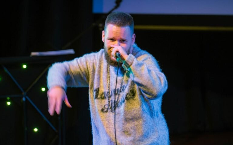 Host Dee Grant on the mic at Slough Open Mic event